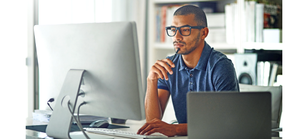 Man in deep thought looking at computer
