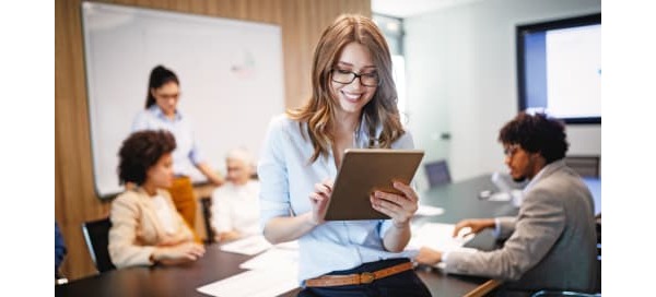 Woman with glasses smiling over Ipad